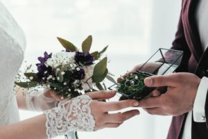 Close up of bride and groom exchanging rings during ceremony.