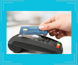 Credit card being used over a credit card reader.