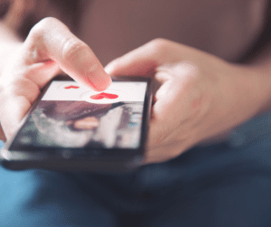 Person using a dating app on a phone.
