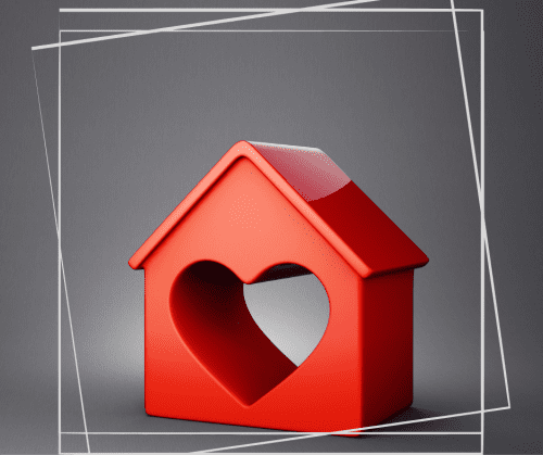 Red wooden toy house on a dark gray background with a heart carved out of the center. 