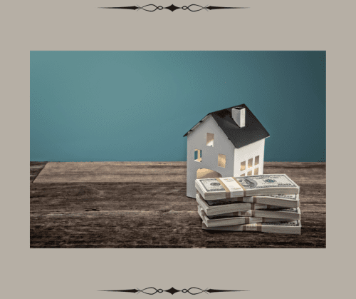 Toy house on a table next to a pile of cash to signify the value of a home. during divorce.
