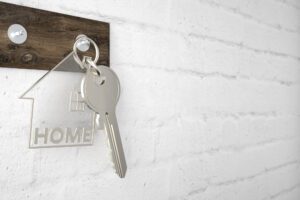 Keychain with plastic home hanging on key hook.