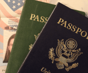 Passport booklets and identification cards on American flag backdrop