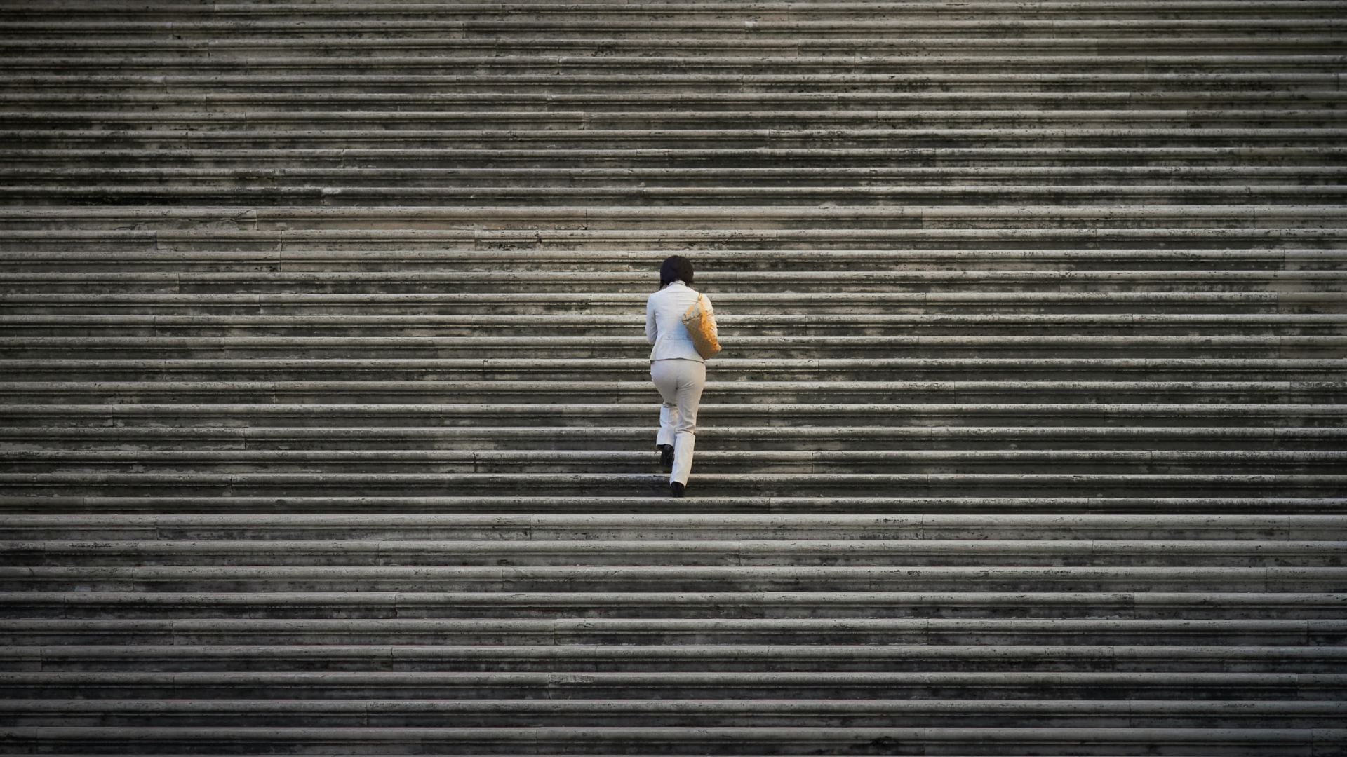 woman walking up concrete steps